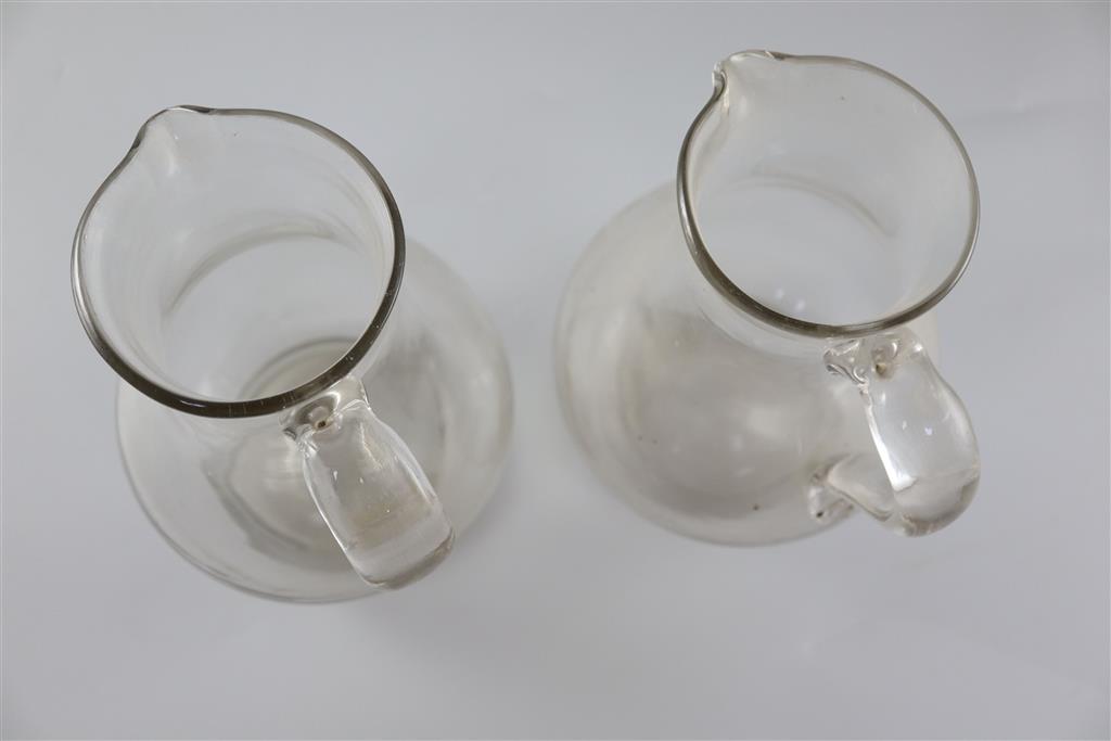 A pair of Georgian glass plain baluster jugs, first half 18th century,